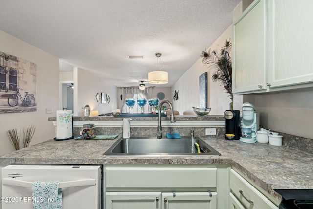 kitchen with dishwasher, a textured ceiling, ceiling fan, sink, and kitchen peninsula