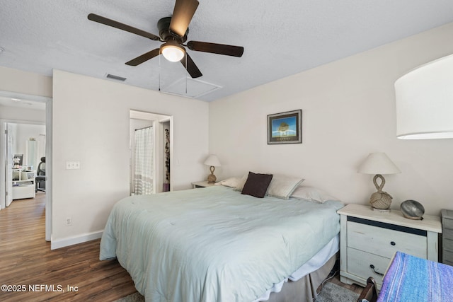 bedroom featuring a textured ceiling, ceiling fan, and dark hardwood / wood-style flooring