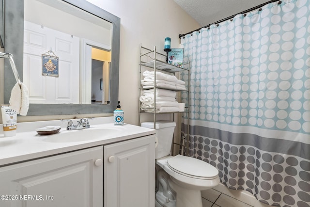 bathroom with vanity, a textured ceiling, toilet, tile patterned floors, and a shower with shower curtain