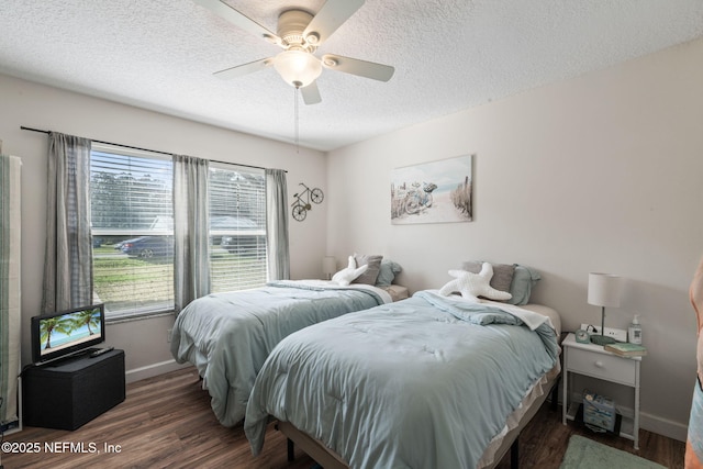 bedroom featuring a textured ceiling, ceiling fan, and dark hardwood / wood-style flooring