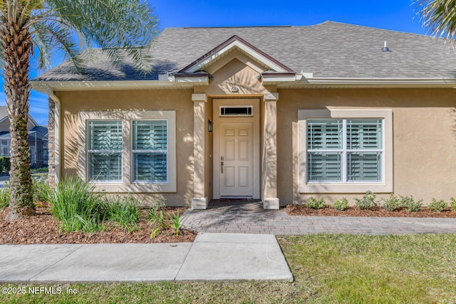 doorway to property with a yard