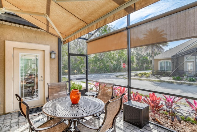 sunroom featuring lofted ceiling