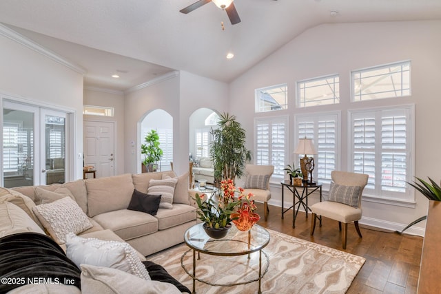 living room with ceiling fan, ornamental molding, dark hardwood / wood-style floors, and lofted ceiling