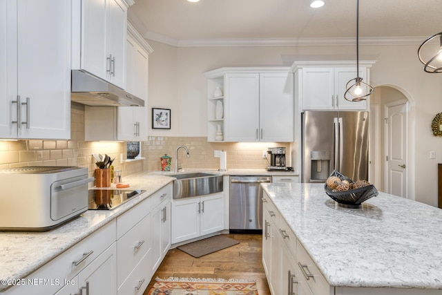 kitchen featuring white cabinets, crown molding, stainless steel appliances, and sink