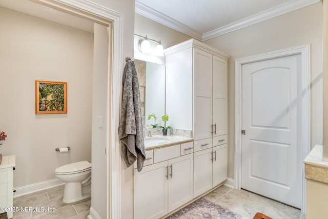 bathroom with toilet, crown molding, tile patterned floors, and vanity