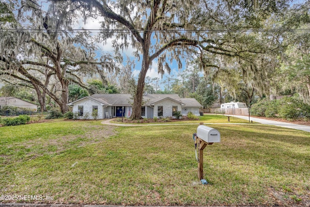 ranch-style house with fence and a front yard