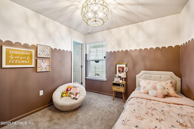 bedroom with carpet, a textured ceiling, and baseboards