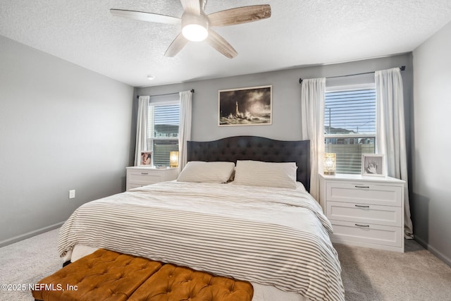 bedroom featuring carpet floors, ceiling fan, baseboards, and a textured ceiling