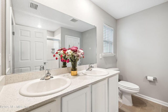 full bathroom featuring visible vents, a sink, and a shower stall