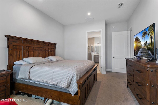 carpeted bedroom featuring connected bathroom