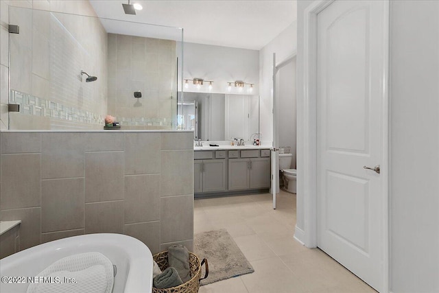 full bathroom with vanity, tile patterned floors, plus walk in shower, and toilet