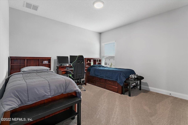 carpeted bedroom featuring a textured ceiling