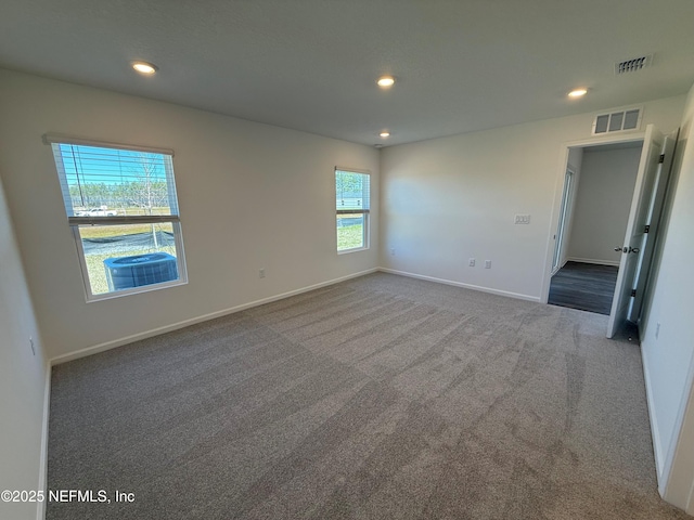 carpeted spare room with recessed lighting and visible vents