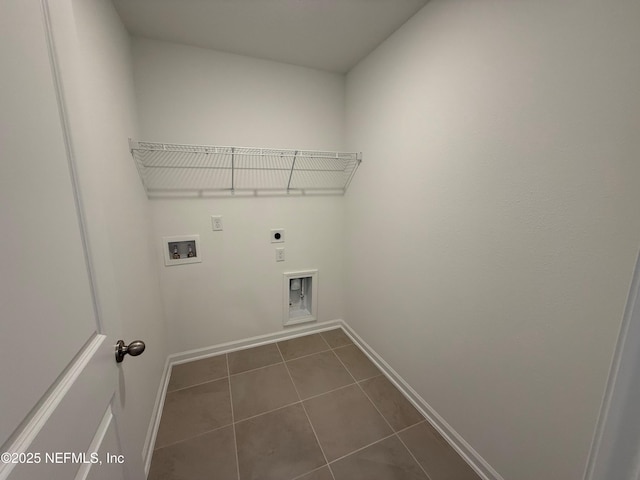 laundry room with baseboards, laundry area, hookup for a washing machine, hookup for an electric dryer, and dark tile patterned flooring
