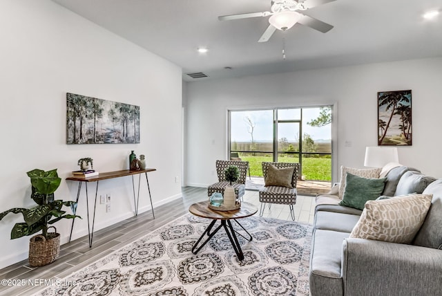 living area featuring baseboards, visible vents, a ceiling fan, wood finished floors, and recessed lighting