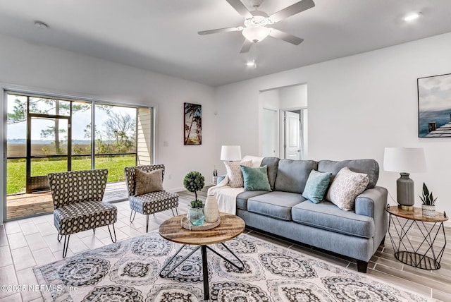 living area featuring ceiling fan, wood tiled floor, baseboards, and recessed lighting