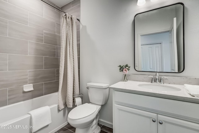 full bath featuring shower / bath combo, vanity, toilet, and baseboards