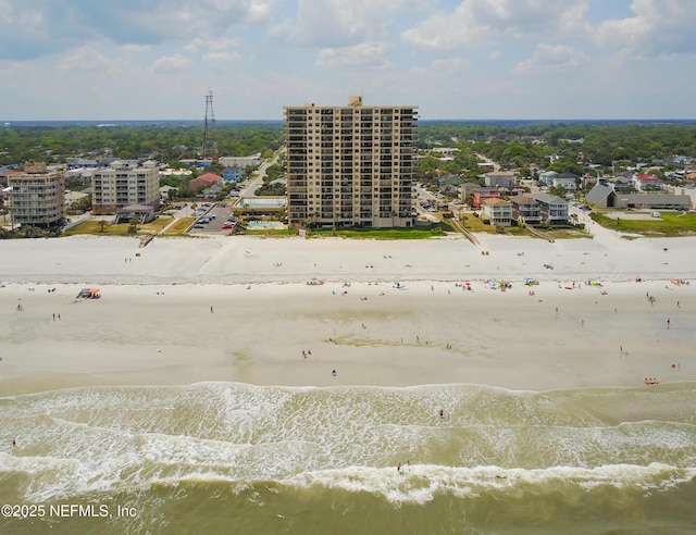 drone / aerial view featuring a water view and a beach view