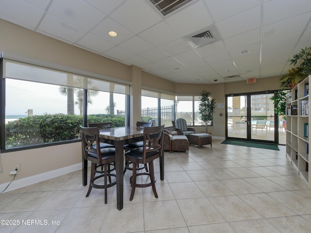 dining room with visible vents, light tile patterned flooring, and a paneled ceiling