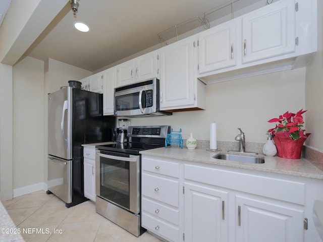 kitchen with a sink, light countertops, white cabinets, and stainless steel appliances