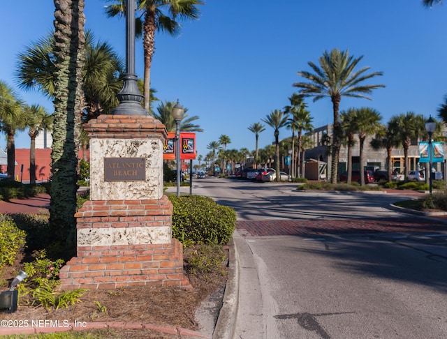 view of road with street lights and curbs