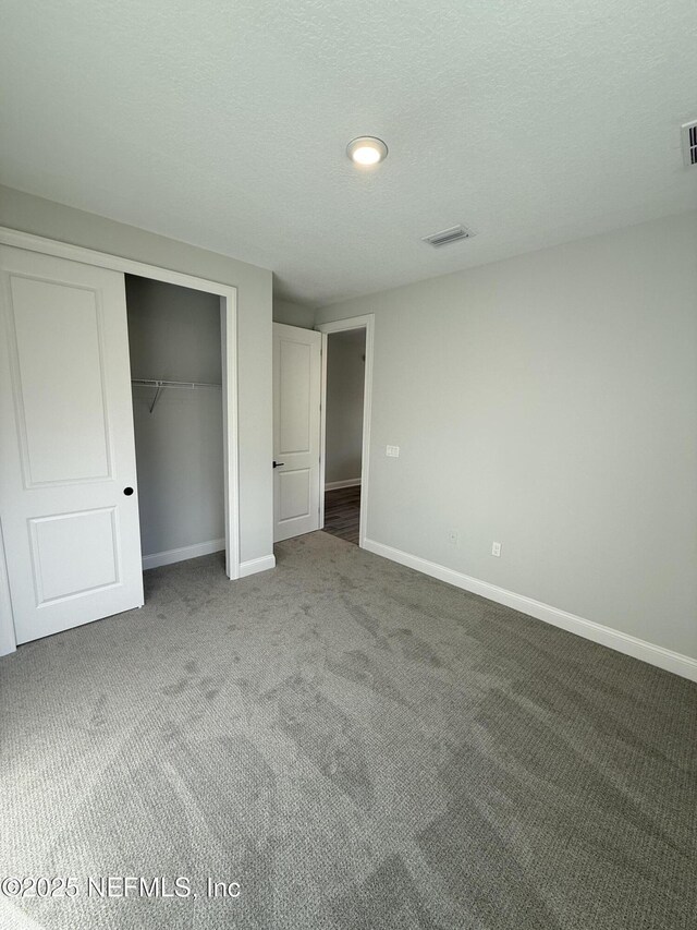 15 Wimbledon Way, Palm Coast, FL 32164 - unfurnished bedroom with a closet, baseboards, visible vents, and carpet floors