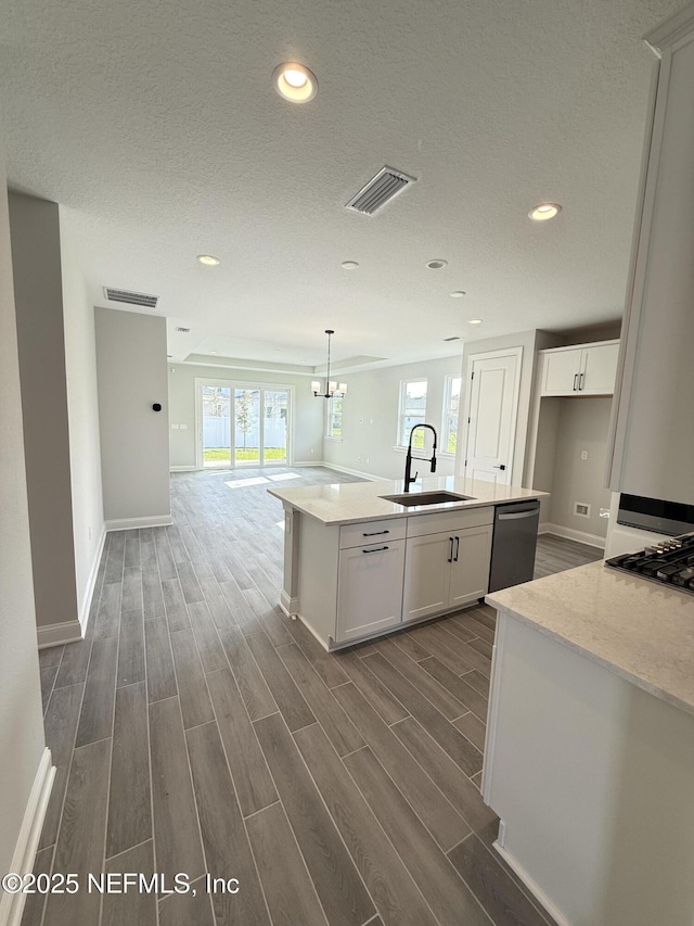 15 Wimbledon Way, Palm Coast, FL 32164 - kitchen with visible vents, wood tiled floor, open floor plan, appliances with stainless steel finishes, and a sink