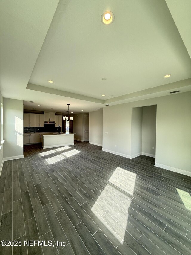 15 Wimbledon Way, Palm Coast, FL 32164 - unfurnished living room featuring baseboards, recessed lighting, visible vents, and wood finish floors