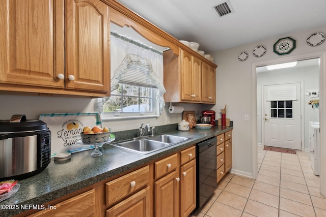 37069 Lee St, Hilliard, FL 32046 - kitchen with black dishwasher, sink, light tile patterned floors, and separate washer and dryer