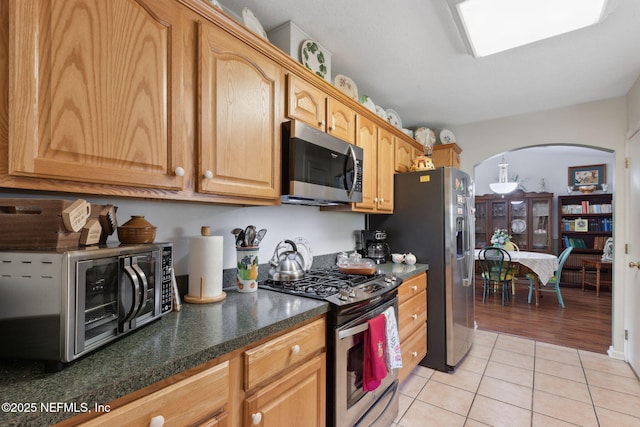 37069 Lee St, Hilliard, FL 32046 - kitchen with light tile patterned flooring, appliances with stainless steel finishes, and dark stone counters