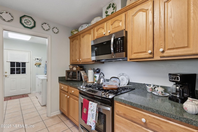 37069 Lee St, Hilliard, FL 32046 - kitchen featuring light tile patterned flooring, appliances with stainless steel finishes, and separate washer and dryer