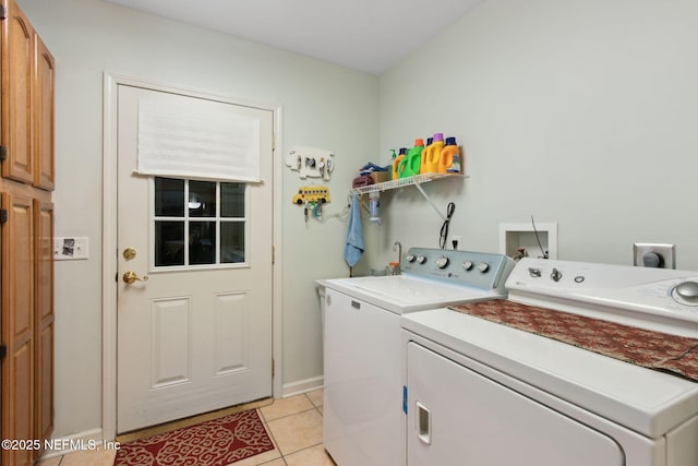 37069 Lee St, Hilliard, FL 32046 - washroom with light tile patterned floors, washer and clothes dryer, and cabinets