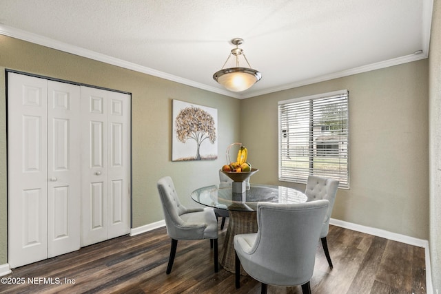 dining area featuring dark wood-style floors, baseboards, and crown molding