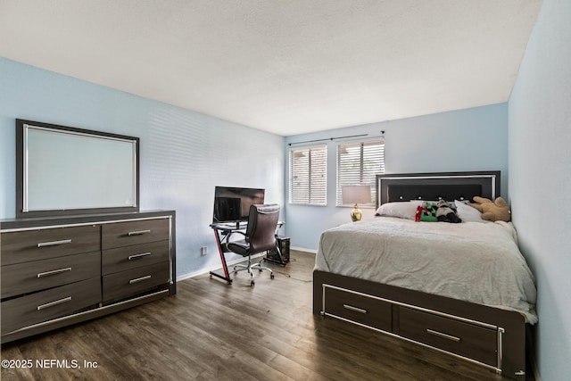 bedroom with baseboards and dark wood finished floors