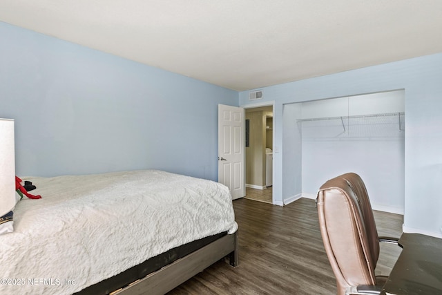 bedroom featuring baseboards, a closet, visible vents, and wood finished floors