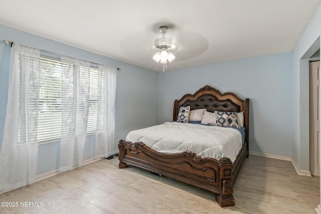 bedroom with ceiling fan and baseboards