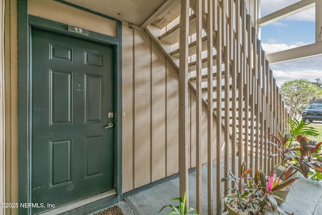 property entrance featuring board and batten siding