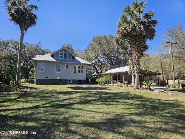 back of property featuring a gazebo and a lawn