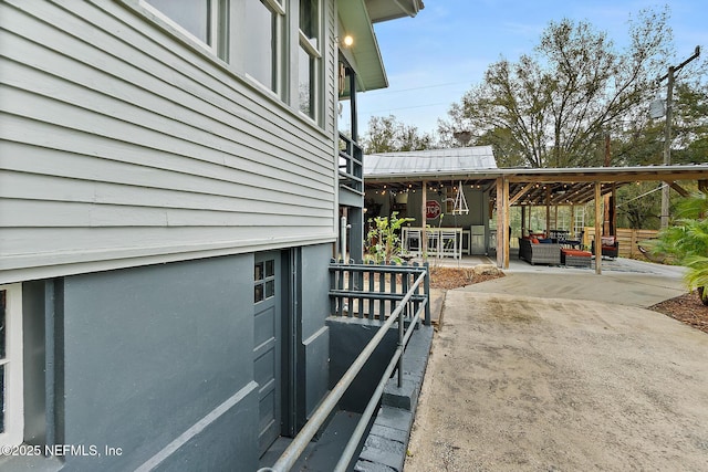 view of side of property with a patio area and an outdoor living space