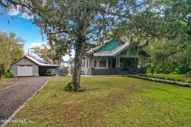 craftsman inspired home with a garage, covered porch, a carport, a front yard, and gravel driveway