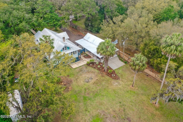 drone / aerial view with a wooded view