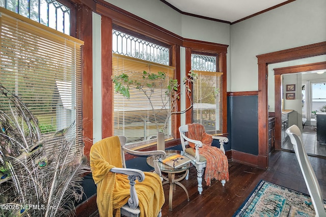 sitting room featuring crown molding and wood finished floors