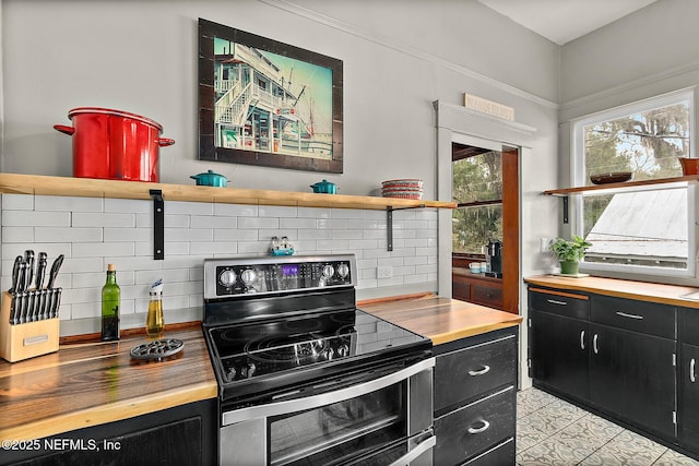 kitchen featuring butcher block countertops, dark cabinetry, backsplash, double oven range, and open shelves