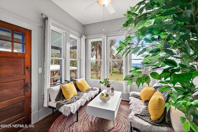 sunroom featuring ceiling fan