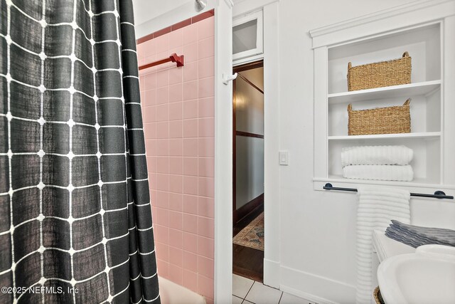 full bath featuring curtained shower and tile patterned floors