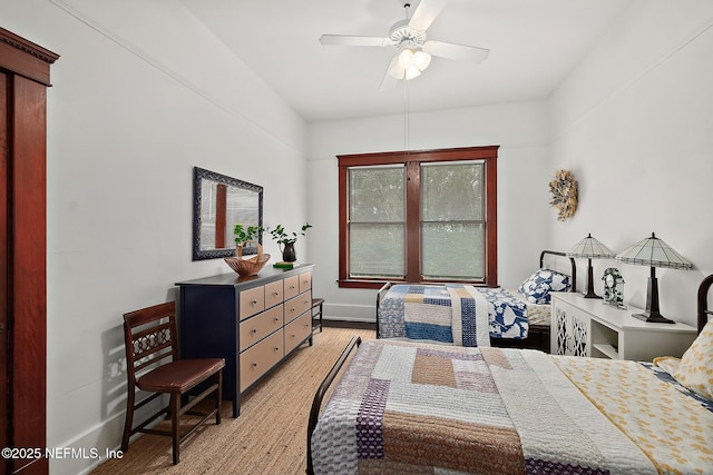 bedroom featuring light wood-style floors, baseboards, and a ceiling fan