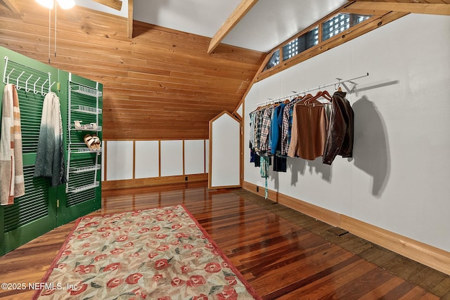 walk in closet with lofted ceiling with beams and hardwood / wood-style floors