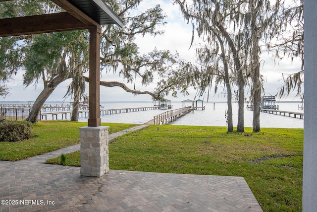 view of yard featuring a water view and a dock