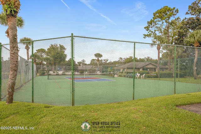 view of sport court featuring fence