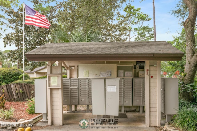 view of community featuring fence and mail area